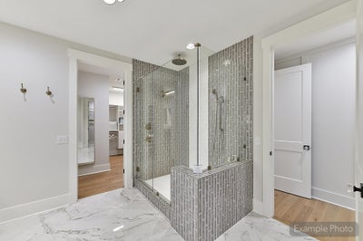 Modern bathroom with gray vertical tile walk-in shower and marble flooring