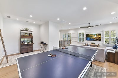 Bonus room with ping pong table, recessed lighting, and hardwood floors
