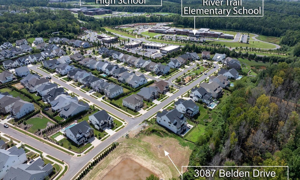 Aerial view of residential neighborhood near high school and elementary school with available lot at 3087 Belden Drive