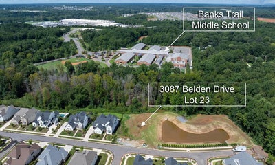 Aerial view of vacant residential lot near Banks Trail Middle School in suburban neighborhood