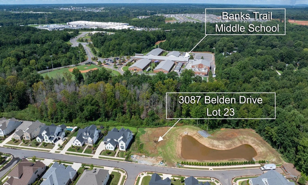 Aerial view of vacant residential lot near Banks Trail Middle School in suburban neighborhood