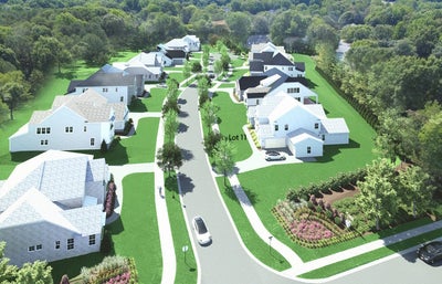 Aerial view of residential subdivision with multiple two-story homes and tree-lined streets