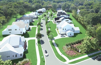 Aerial view of residential subdivision with multiple two-story homes and tree-lined streets