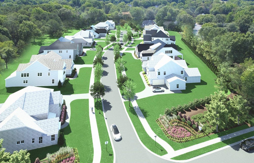 Aerial view of residential subdivision with multiple two-story homes and tree-lined streets