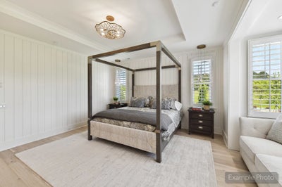 Bedroom with four-poster bed, shiplap walls, hardwood floors, and decorative ceiling light fixture