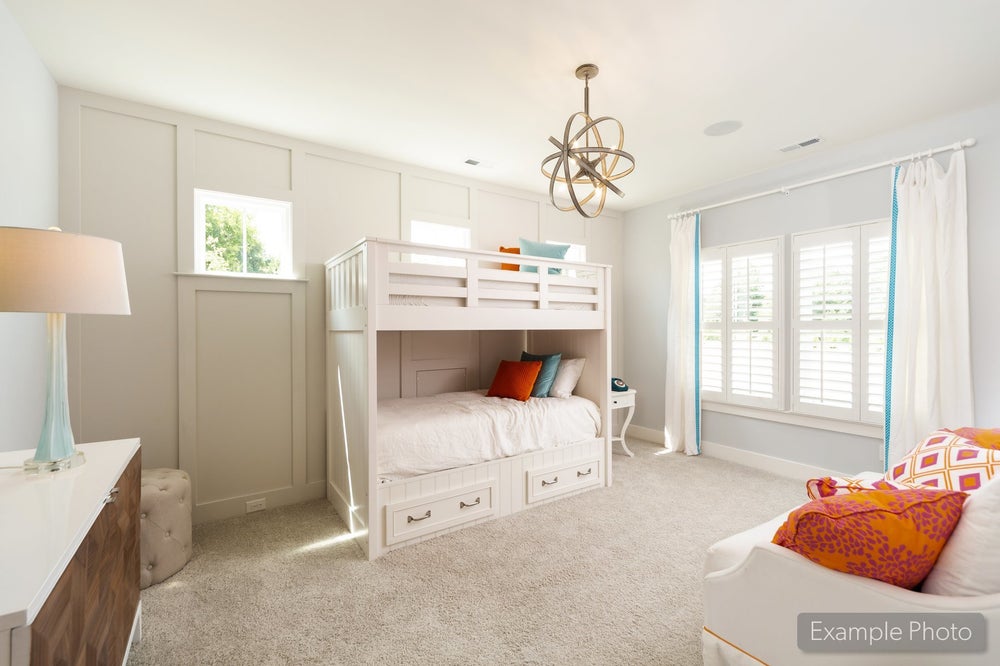 Children's bedroom with white bunk bed, built-in drawers, carpet flooring, and an orb chandelier