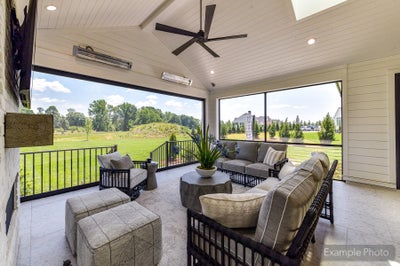 Covered patio with vaulted shiplap ceiling, ceiling fan, outdoor seating, and open views of a green backyard
