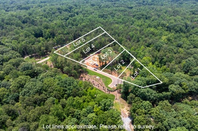 Aerial view of five labeled wooded residential lots with marked boundaries surrounded by trees and a curved road.