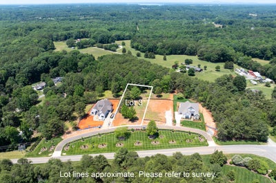 Aerial view of Lot 3, a residential building lot surrounded by trees and neighboring homes in a suburban subdivision.