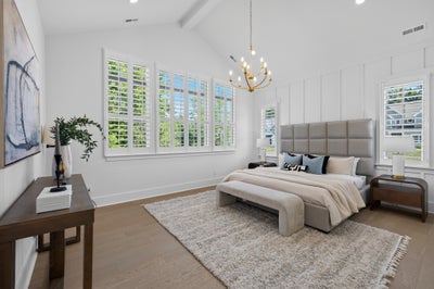 Master bedroom with vaulted ceiling, chandelier, plantation shutters, and hardwood floors