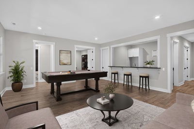 Finished basement rec room with pool table, wet bar, hardwood floors, and seating area