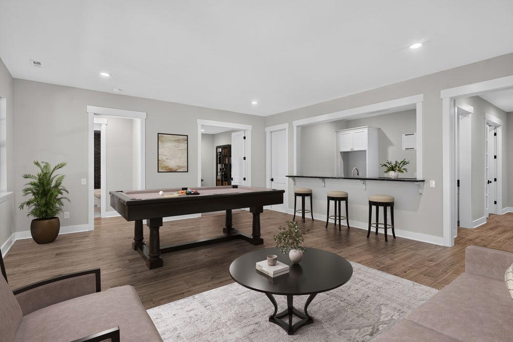 Finished basement rec room with pool table, wet bar, hardwood floors, and seating area