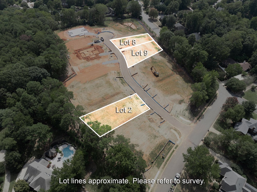 Aerial view of a residential development with Lots 2, 8, and 9 highlighted along a curved street under construction.